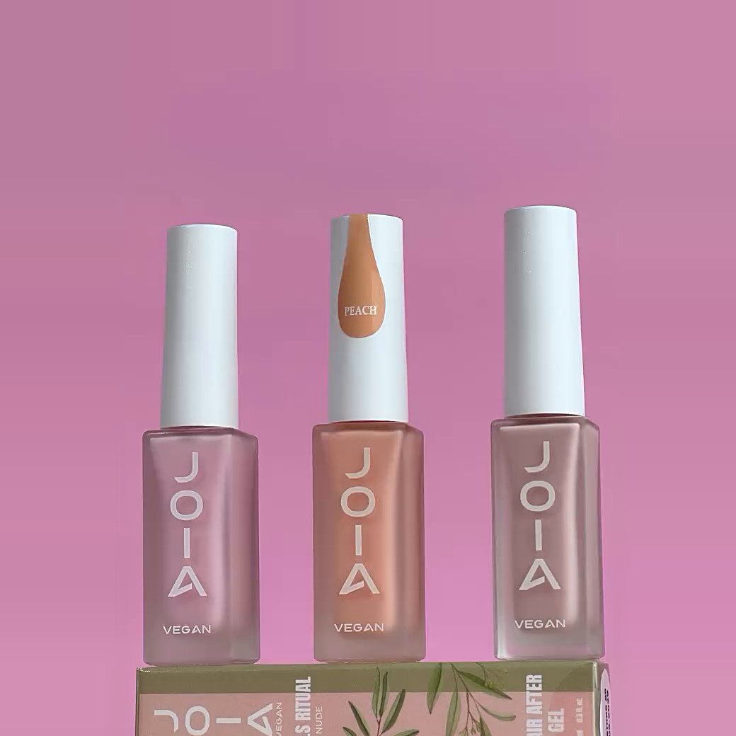 Three JOIA Vegan bottles in pink, peach and nude